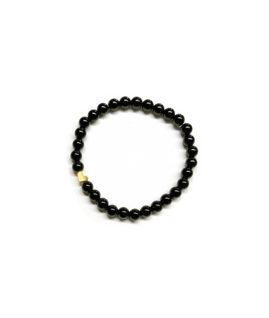 Pulsera de Ónix( bolas de 6mm) con símbolo de corazón dorado.

En goma elástica.

Tarjeta exclusiva en 3 idiomas.
