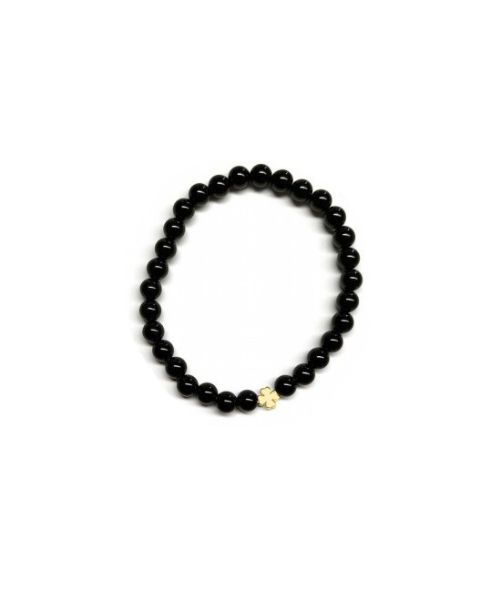 Pulsera de Ónix( bolas de 6mm) con símbolo de trébol dorado.

En goma elástica.

Tarjeta exclusiva en 3 idiomas.