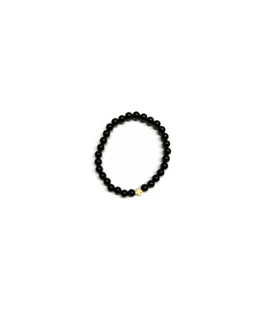 Pulsera de Ónix( bolas de 6mm) con símbolo de trébol dorado.

En goma elástica.

Tarjeta exclusiva en 3 idiomas.