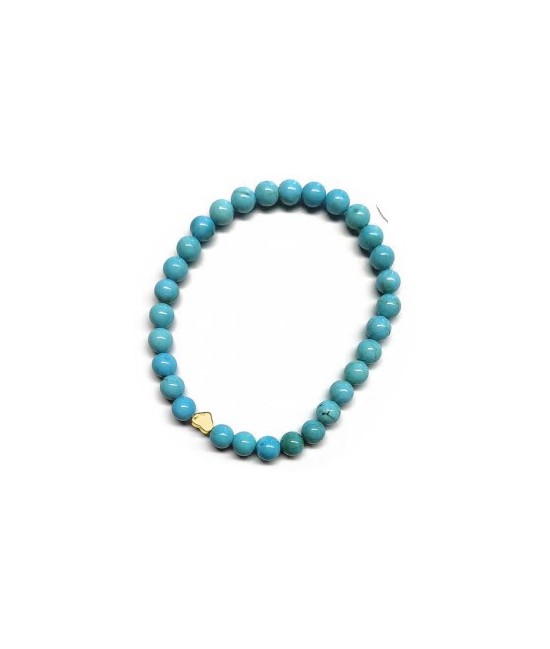Pulsera de Turquenita (bolas de 6mm) con símbolo de corazón dorado.

En goma elástica.

Tarjeta exclusiva en 3 idiomas.
