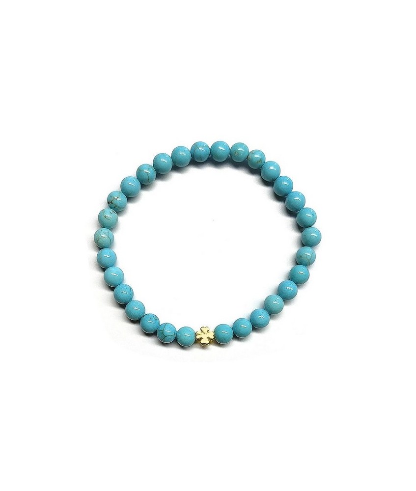 Pulsera de Turquenita (bolas de 6mm) con símbolo de trébol dorado.

En goma elástica.

Tarjeta exclusiva en 3 idiomas.