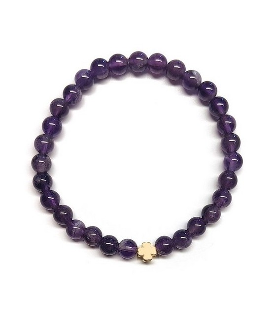 Pulsera de Amatista (bolas de 6mm) con símbolo de trébol dorado.

En goma elástica.

Tarjeta exclusiva en 3 idiomas.
