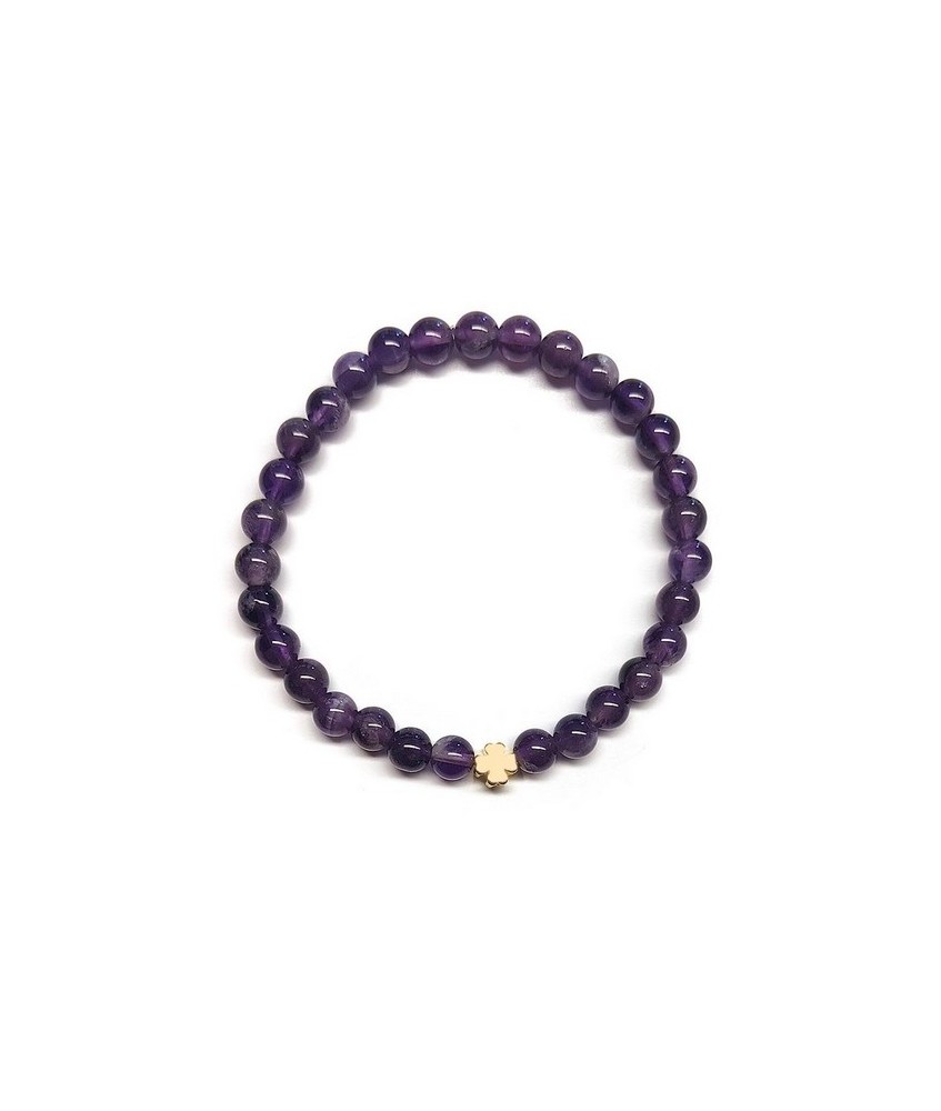 Pulsera de Amatista (bolas de 6mm) con símbolo de trébol dorado.

En goma elástica.

Tarjeta exclusiva en 3 idiomas.